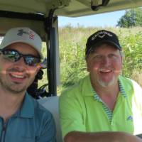 Two more men in golf cart